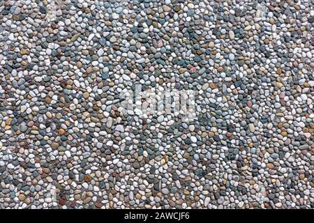 Exposed aggregate concrete with different colored pebbles Stock Photo