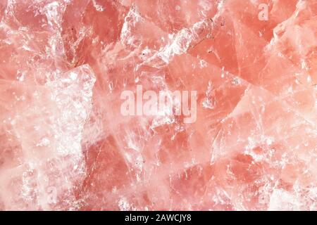 Isolated macro of large semi precious gemstone rose quartz surface showing matrix and texture Stock Photo