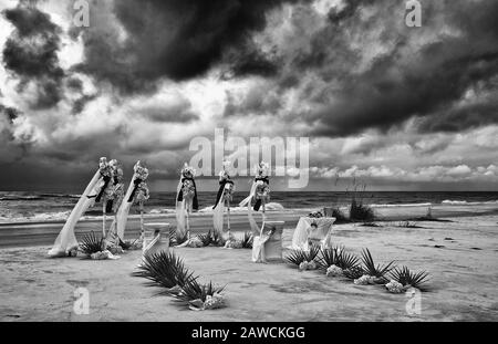 A Dramatic Image of a Wedding Set Up on a Stormy Beach. Filter applied for effect. Stock Photo