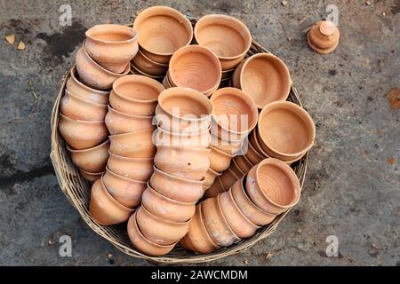 Clay cups in basket on the street. Kolkata. India Stock Photo