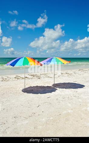 Two Bright Color Beach Umbrellas on the Beach Stock Photo
