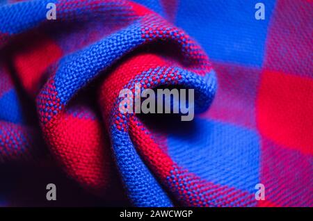 Plaid material. Red and blue cage clothes. Crumpled twisted fabric background Stock Photo