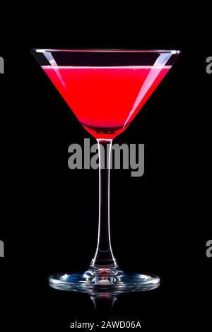 Strawberry margarita cocktail in martini glass isolated on black background