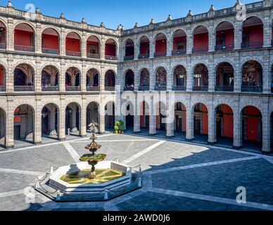 Tourists observe the murals of Diego Rivera in the National Palace in Mexico City, Mexico. Stock Photo