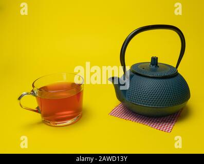 https://l450v.alamy.com/450v/2awd13y/process-brewing-teatea-ceremonycup-of-freshly-brewed-red-teasoft-light-yellow-background-2awd13y.jpg