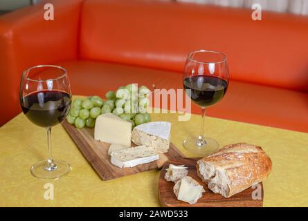 Wine and cheese pairing with colorful yellow and orange background Stock Photo