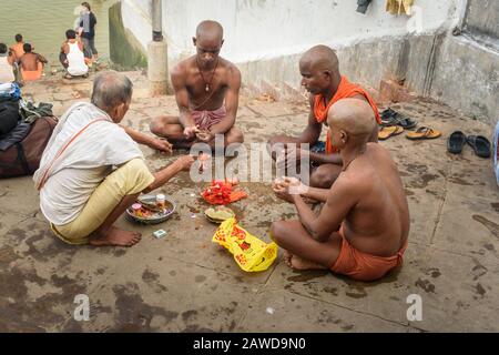 Indian people perform Hindu religious rituals near Hooghly or Ganga river in morning. Kolkata. India Stock Photo