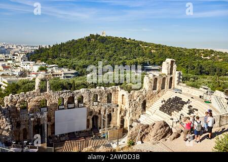 ATHENS, GREECE - 2019 May 18: Tourists in ancient old theater ruins in a summer day in Acropolis Greece, Athens Stock Photo