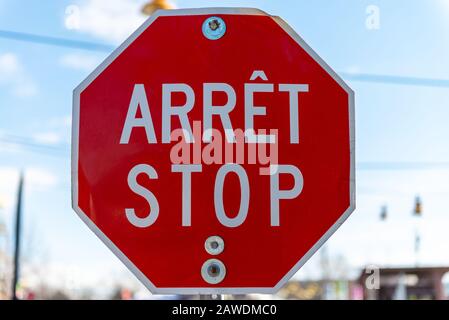 Bilingual stop sign in French and English taken in Quebec Canada Stock Photo