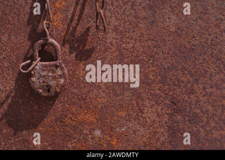 Sheet, padlock and chain. Corrosion of metal objects. Stock Photo