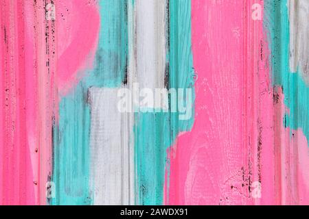 Wooden shabby fence painted in white, turquoise and pink. Close up. Texture, background Stock Photo