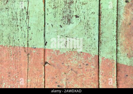 Wooden shabby fence painted in light green and beige color. Close up. Texture, background Stock Photo
