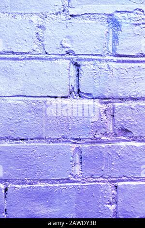 Brick wall as a texture painted in purple. Vertical. Stock Photo