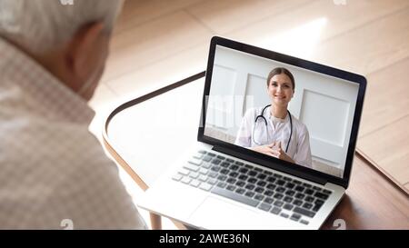 Elderly man having online video consultation with doctor Stock Photo