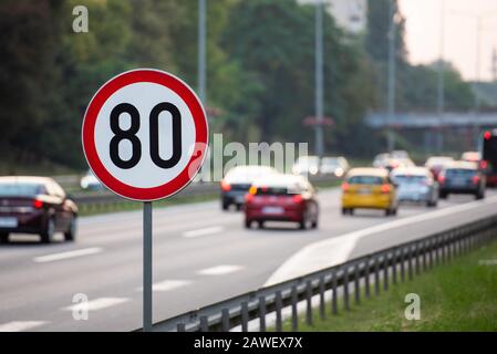 80km/h Speed limit sign a highway full of cars Stock Photo