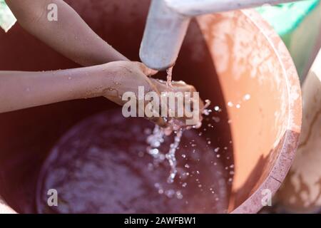 Happy African ethnic Girl Engaged with Clean Water in an arid zone Stock Photo