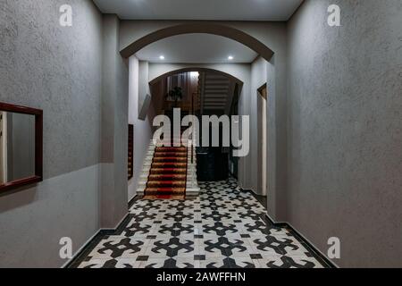 Old vintage staircase in entrance hall of hotel. Stock Photo