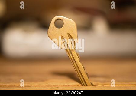 Key stuck in the table. key on wooden background. safety and security concept Stock Photo