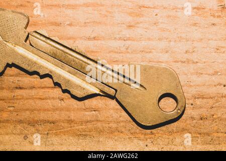 Pair of keys isolated on wooden background. safety and security concept Stock Photo
