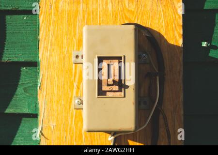 Vintage electrical switch panel. retro power toggle on the wooden wall Stock Photo