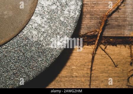 Old rusty grindstone in workshop. whetstone close up Stock Photo