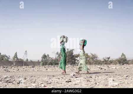 Cheerful African Ethnicity Infant Carrying Healthy Water for a dehydration concept Stock Photo