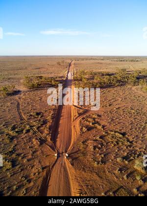 Aerial of red dirt unsealed road as it passes through the flood plains of the Darling River near Mount Murchison outback New South Wales Australia Stock Photo