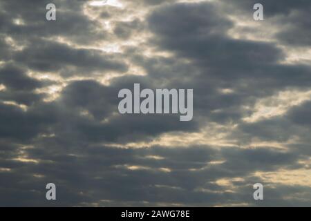 Sunlight shines through the cloudy sky. stormy sky with sunbeam. overcast weather Stock Photo