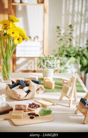 Dried rose buds, leaves and badian flowers for making soap bars on table in workshop Stock Photo