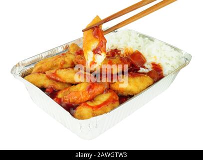 Chinese crispy battered chicken and rice with sweet and sour sauce in a foil take away tray isolated on a white background Stock Photo