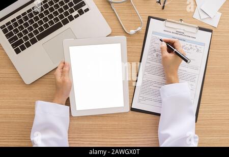 Doctors use tablets to search for patient data. view from above. Free space on tablet screen for your text. Stock Photo
