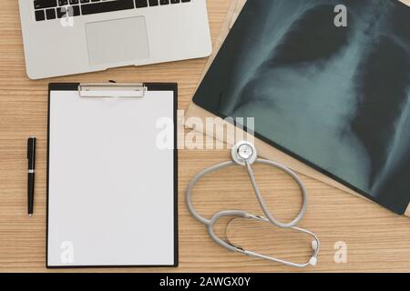 Computer, film x-ray, clipboard on doctors desk. view from top Stock Photo