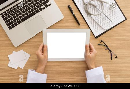 Doctors use tablets to search for patient data. view from above. Free space on tablet screen for your text. Stock Photo