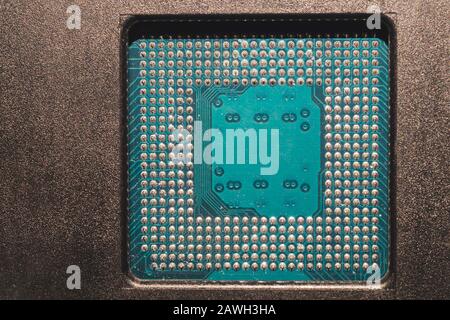 Processor pins macro. computer motherboard close up. cpu pins on a circuit board. micro elements of computer central processor unit. modern technologi Stock Photo