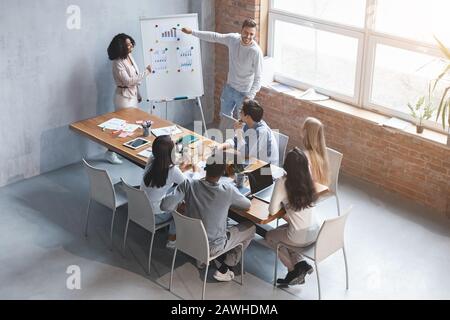 Man and woman making business presentation to colleagues in office Stock Photo