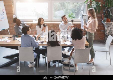 Female manager making marketing report at business meeting Stock Photo