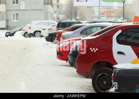Cars on a city street in winter covered with snow. Stock Photo
