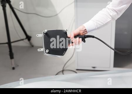 Operator doing quality control or inspection with handheld professional 3D laser scanner Stock Photo