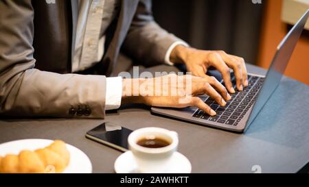 Cropped image of busy guy using computer Stock Photo