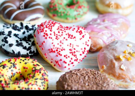 Doughnuts donuts various types of cakes with heart fat thursday Valentine's Day concept Stock Photo