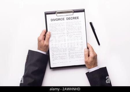 Husband reading legal document about divorce on white Stock Photo