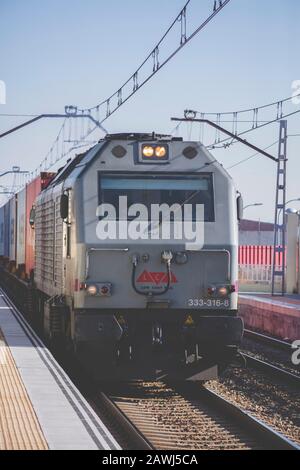 Alcala de Henares train station, Madrid province, Spain; Feb/25/2019; Cargo train passing by the station of Alcala de Henares, Madrid province, Spain Stock Photo