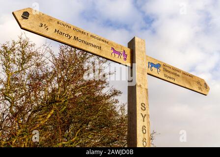 South Dorset Ridgeway sign post pointing to Hardy Monument one way and villages of Bincombe and Upwey the other way Stock Photo