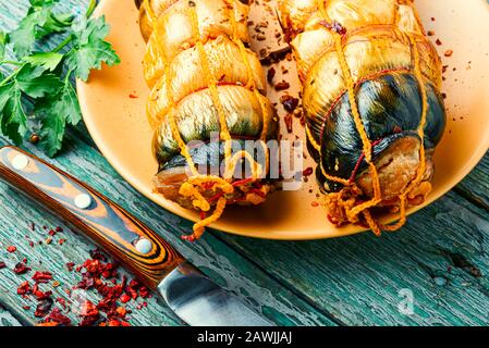 Hot smoked mackerel roll.Delicious smoked fish on plate Stock Photo