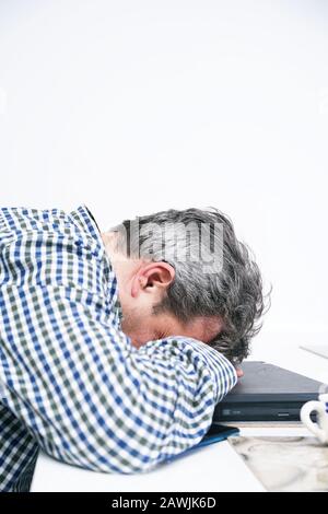 Remote IT support. Tired man works at home Stock Photo