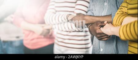 Creative team meeting hands together in line. Young business people are holding hands. Unity and teamwork concept. Stock Photo