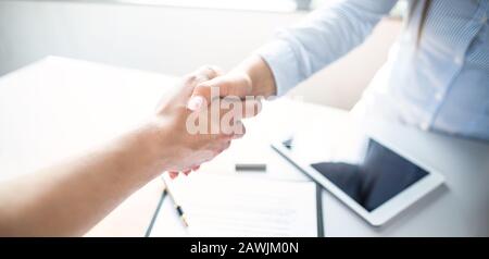 Business people shaking hands, finishing up meeting. Successful businessmen handshaking after good deal. Stock Photo