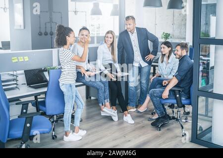 Team at work. Group of young business people working together in creative modern office. Stock Photo
