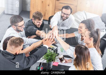 Business people happy showing team work and giving five in office. Teamwork concepts. Stock Photo