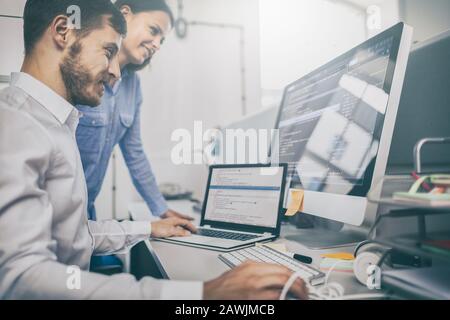 Developing programming and coding technologies. Website design. Programmer working in a software develop company office. Stock Photo
